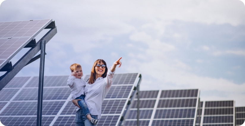 The image shows a happy woman standing between solar panels