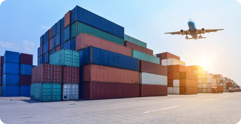 in the image a logistics plane is flying and at the bottom there are containers for logistics