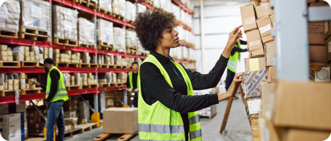 employee inspects products in the warehouse